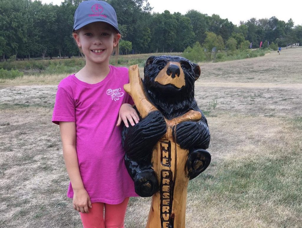 Hayden posing with wooden bear at The Preserve DGC